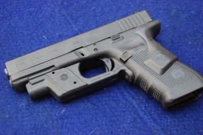 Last year I used a Glock 17 with rear activated laser and front activated light.