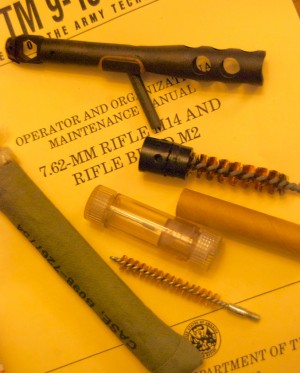 The M1A multi-purpose tool and cleaning kit are accessories that fit in two hollowed-out stock tubes