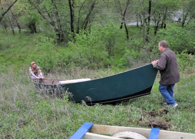 Dave, left, and Ron Bakken push their homemade drift boat toward the Eau Claire River in western Wisconsin.