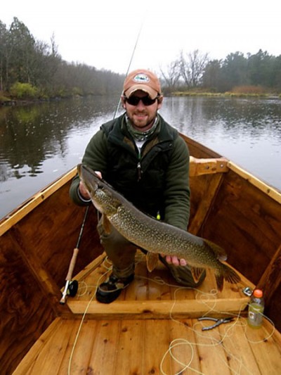 Dave Bakken with a northern pike he caught from his drift boat while fishing a northern Wisconsin river.