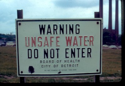 A health warning sign off the Detroit River under the Ambassador Bridge from the 1960s.