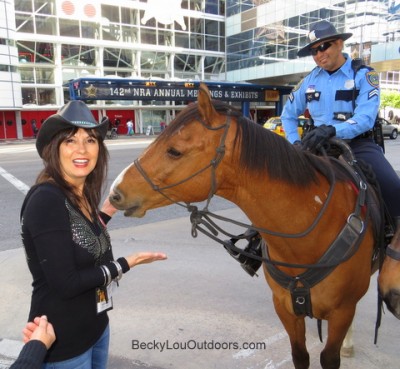Outside of the NRA Convention, Vinson the Police Horse demands another “well deserved” peppermint by nibbling at Becky Lou's hands and shirt sleeve!