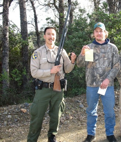 A California game warden issues a Caught Doing Good certificate to a sportsman. 
