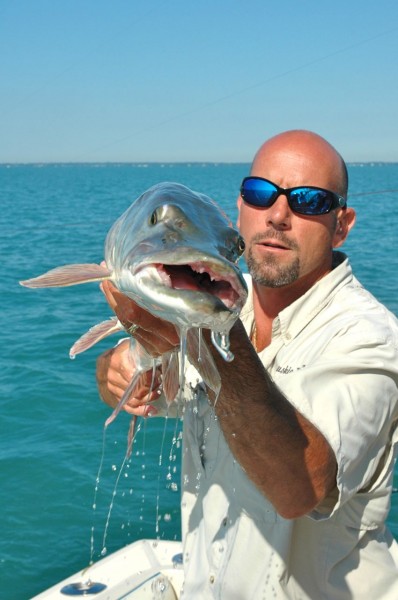 Captain Kevin Backus of Mr. Muskie Charters poses with a fish for a quick picture before releasing it.