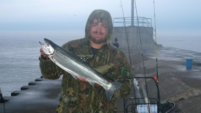 Clyde Brazie of Hartford, Michigan, was one of the successful anglers Tuesday and shows one of two steelhead he caught on shrimp below a bobber.