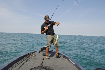 Marcel Veenstra swings a smallmouth bass into his boat.