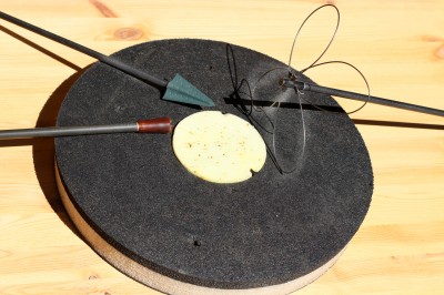 My practice-with-a-partner target consists of a dinner plate-sized foam target with a black outer ring and three-inch yellow inner ring.