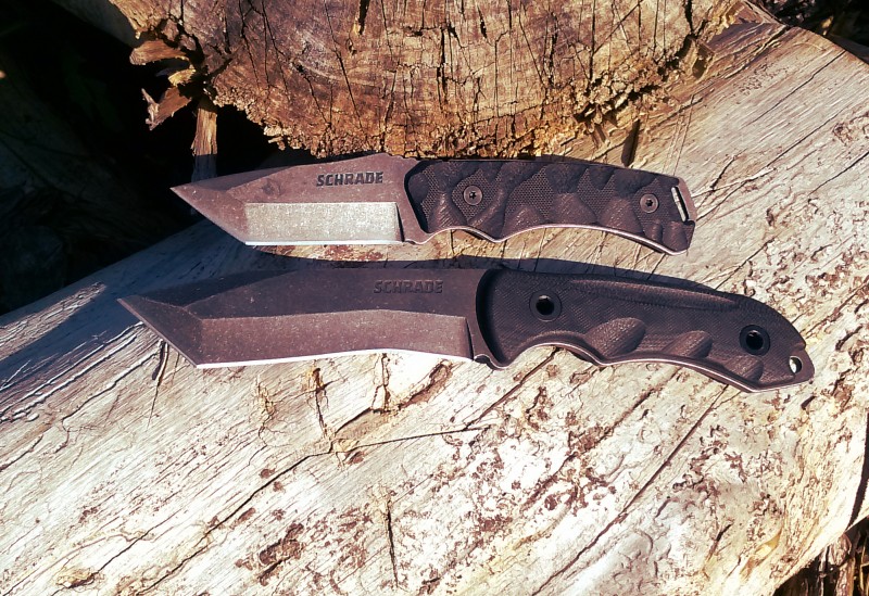 Here we see two Schrade knives resting on a log in the late afternoon.