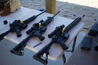 The Media Day range at the Crimson Trace Midnight 3 Gun Invitational displayed especially good manners. Note all guns pointed down range, tables with chambers open and chamber flags in place. 