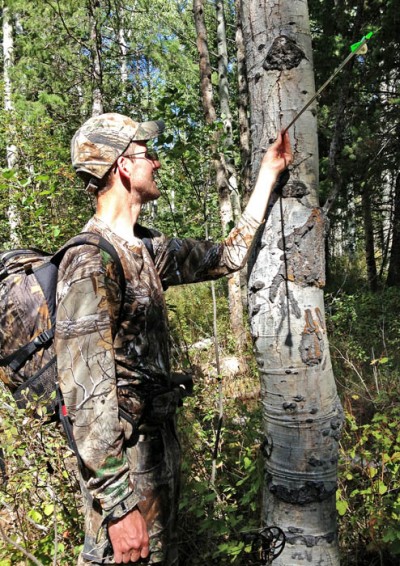Chris White examines his arrow after missing a shot in the final hour of his weeklong bowhunt.