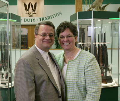 Miles hall poses with his wife at H&H Shooting Sports.