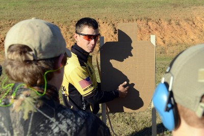 Staff Sgt. Daniel Horner, U.S. Army Marksmanship Unit, explains shots on a target Oct. 26 during the 6th annual USAMU Action Shooting Junior Clinic at Krilling Range.