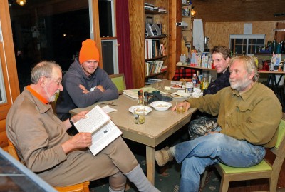 Tom Heberlein, left, relives a hunting story written in the logbook that he keeps at his deer shack in northwestern Wisconsin.