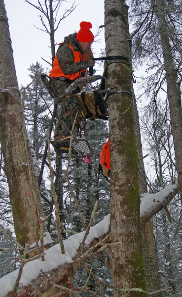 A hunter at the Old T deer camp in northwestern Wisconsin descends from a ladder stand where Chris White shot his eight-point buck on opening day of the state’s firearms deer season.
