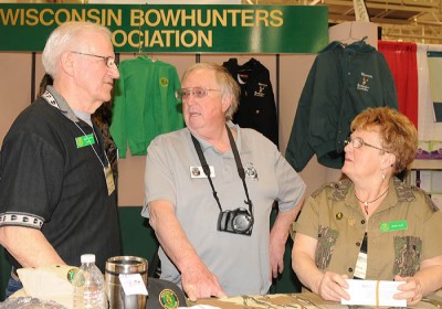 From left, Wright Allen, Glenn Helgeland, and Shirley Allen talk at the Wisconsin Bowhunters Association booth April 5 at the Deer & Turkey Expo in Madison.