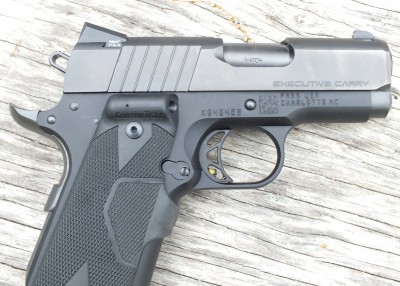 This Para Executive Carry has a grip-mounted laser with the activation button in front. The author believes this is the best system because activating the laser is easy and requires no conscious effort.