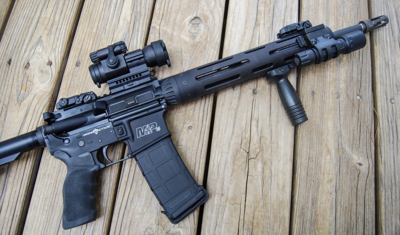 The author's first home-defense configuration of the M&P15 VTAC I, featuring a vertical foregrip, Aimpoint PRO red dot sight, and the rifle's included SureFire G2.