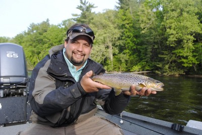 Justin Welsh shows off abrown trout taken on a tiny Thunderstick.
