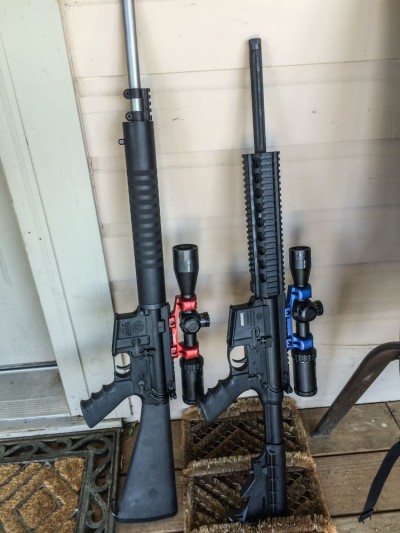 A pair of Smith & Wesson M&P 15 Performance Center rifles. The one on the left is chambered in .22 LR, the one on the right 5.56mm.