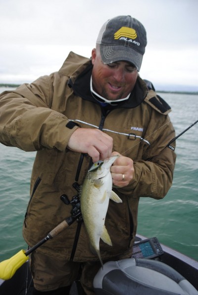 Chris Noffsinger unhooks a smallmouth taken on a rattling bait.
