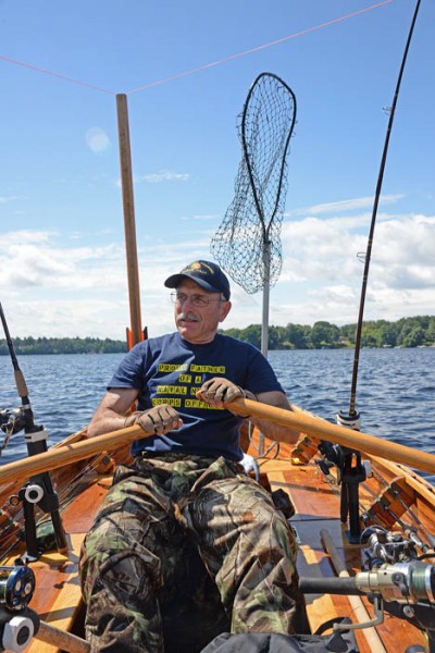 Patrick Durkin rows his cedar-strip rowboat on Lake Wissota near Chippewa Falls.