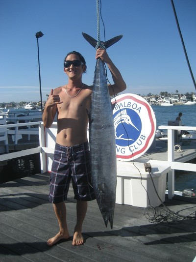 Eric Kim stands next to his one-of-a-kind wahoo. 