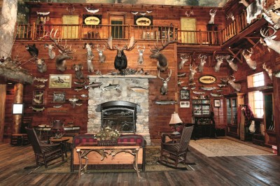 Lobby and fireplace feature in the East Peoria, Ill. Bass Pro Shops Outdoor World (similar to one that will be in Tacoma Bass Pro Shops). The outdoors feel is brought indoors through massive log and rock work, large indoor aquariums, and water features stocked with native fish species as well as an extensive collection of museum quality fish and wildlife mounts.  