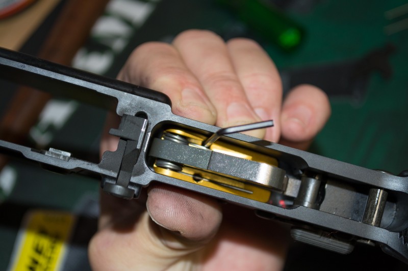 Tighten two set screws to "jam" the trigger group assembly into place, creating pressure against the trigger group pins.