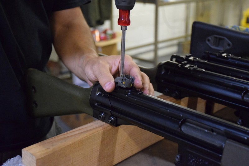 Joe Stoppiello installs a rear sight on a G3-pattern rifle at his shop in Canton, Michigan.