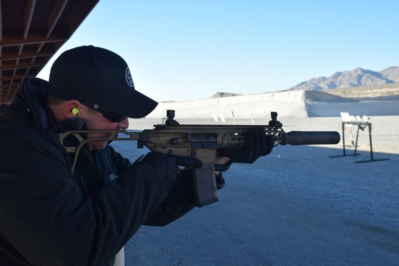 A SIG employee shoots a suppressed, nine-inch-barreled MCX in 300 BLK. Image by Matt Korovesis.