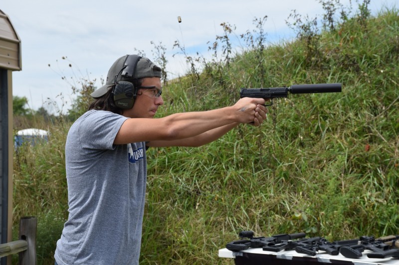 The author shoots a suppressed VP9. Sticking out your tongue while shooting has been proven to tighten shot groups by an average of 0.25 MOA. Image by Joe Stoppiello.