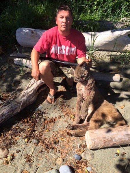 Shawn Hanson and the young cougar that tried to eat his dog.