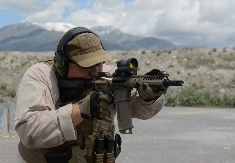 The author putting rounds downrange with an LWRCI carbine.