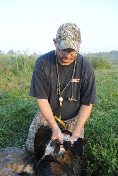 DNR biologist Joe Robison examines tail feathers to age a goose.