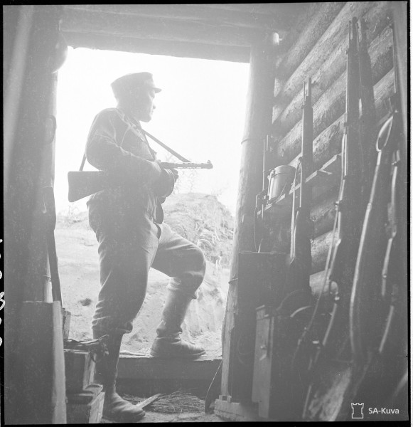 A Finnish soldier looks out from a fortified position. Date taken: June 21, 1944.