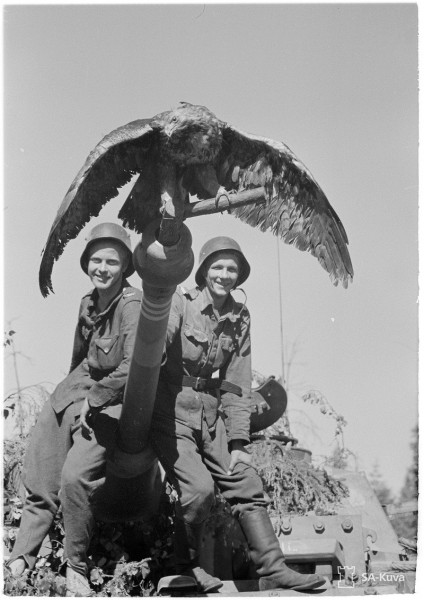 A tank crew with its "mascot." Date taken: July 2, 1944.