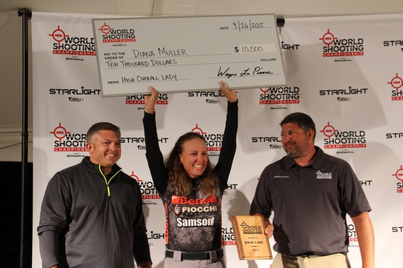 Overall ladies winner Dianna Muller hoists her first-place check.