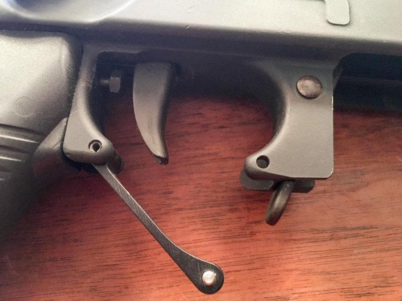 The plunger behind the trigger controls weight of the second stage pull and is adjustable. Note that the trigger guard opens for gloved use. 