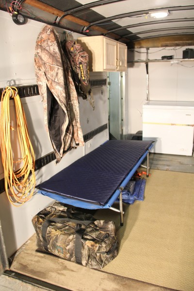 With the simple addition of a cot, I can comfortably sleep in the trailer. A small electric heater run by a generator keeps it warm. 