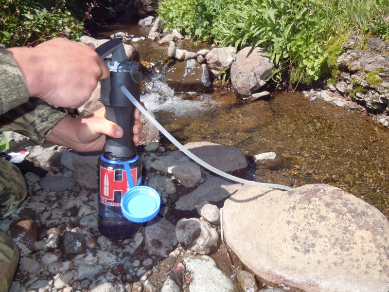 Filtering water with a Katadyn.