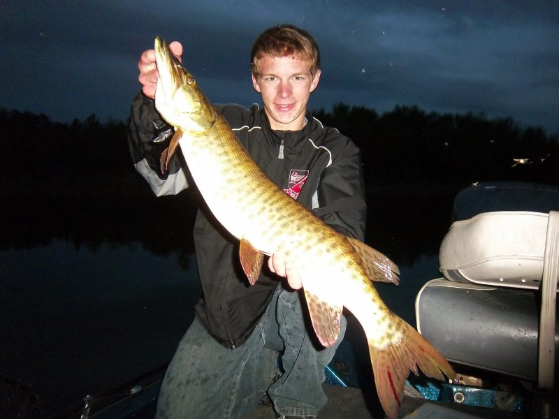 The author’s son, Dawson, with a nighttime muskie caught on a topwater.