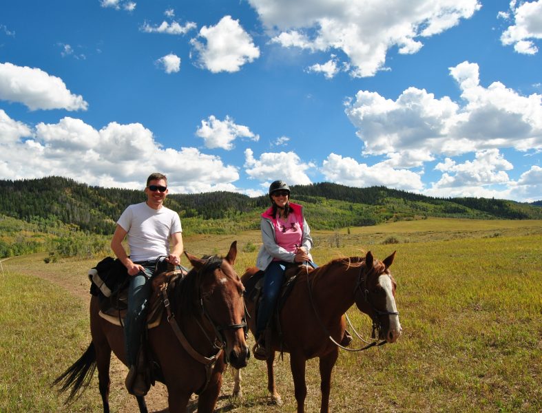 Horseback riding in the high meadow.