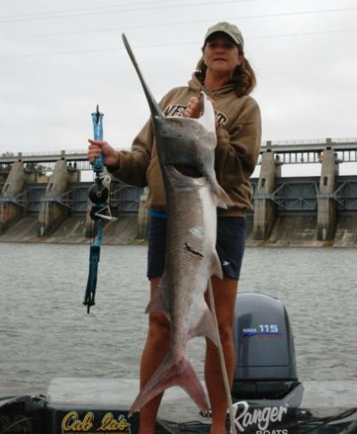 Deb with a paddlefish taken with bowfishing gear.