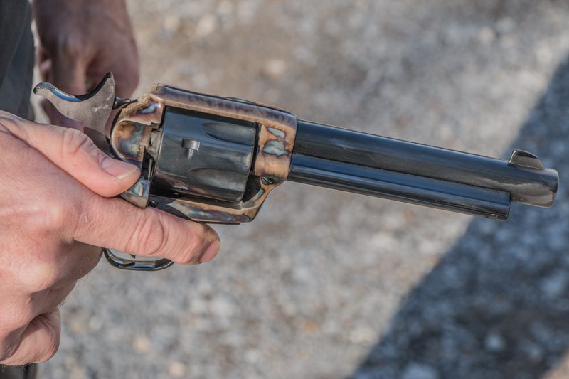 After placing the hammer in the half-cock position – this step is not necessary with a Ruger single action – open the loading gate with your thumb.