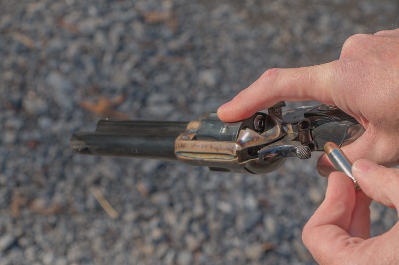 With practice, loading a single action while keeping it in your shooting hand is easy; rotate the cylinder with your trigger finger and insert the cartridges with your support hand.