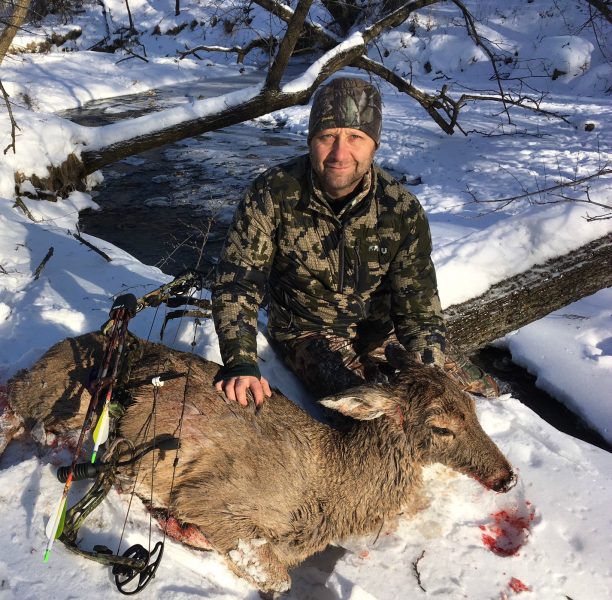 Scott Gulden with a mature doe arrowed on December 27. The deer looks wet because she died in the creek.