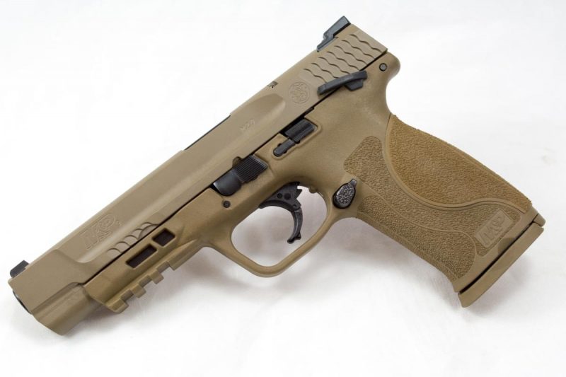 The M&P 9 M2.0 model with 5-inch barrel, flat dark earth Cerakote, and manual safety. The front cocking serrations are subtle; useful for a press check, but out of the way.